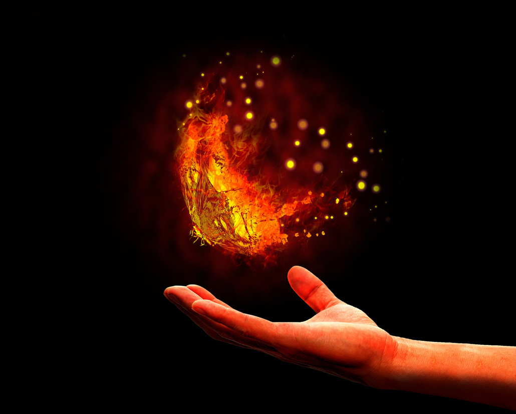 picture of fire butterfly on black background with hand underneath