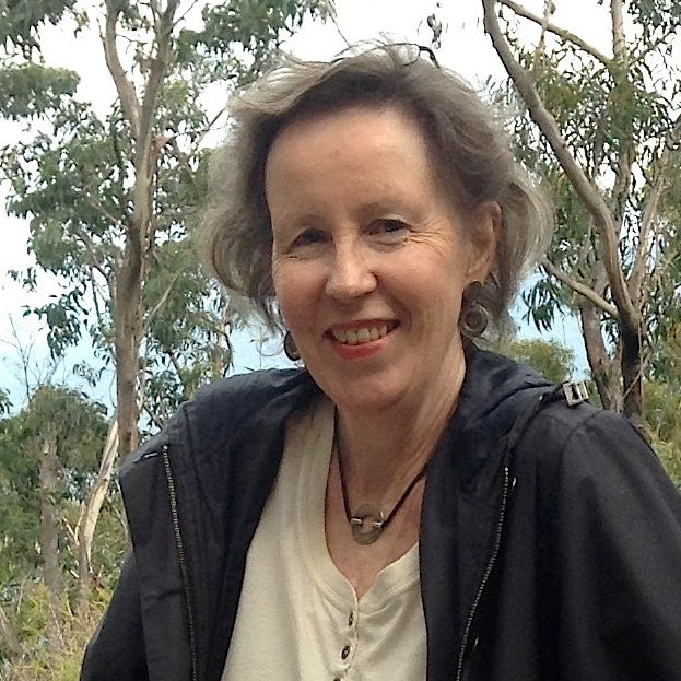 a portrait photo of a smiling woman with a nature backdrop